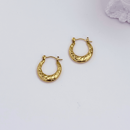 Molten Swirl Gold Hoop Earrings on white background