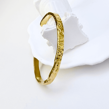 gold molten wave cuff bracelet with textured finish, adjustable and elegant design