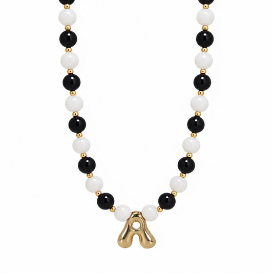 14K gold filled necklace with alternating black onyx and white mother-of-pearl beads, gold spacers and bubble initial letter
