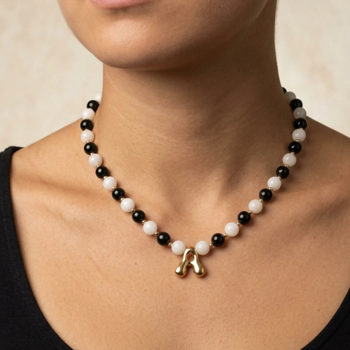 14K gold filled necklace with alternating black onyx and white mother-of-pearl beads, gold spacers and bubble initial letter