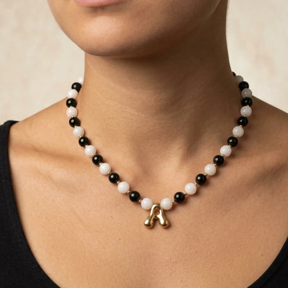 14K gold filled necklace with alternating black onyx and white mother-of-pearl beads, gold spacers and bubble initial letter