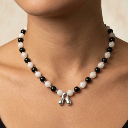 personalised sterling silver necklace with alternating black onyx and white mother-of-pearl bead, gold spacers and bubble initial