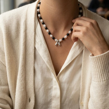 personalised sterling silver necklace with alternating black onyx and white mother-of-pearl bead, gold spacers and bubble initial