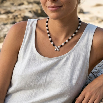 personalised sterling silver necklace with alternating black onyx and white mother-of-pearl bead, gold spacers and bubble initial