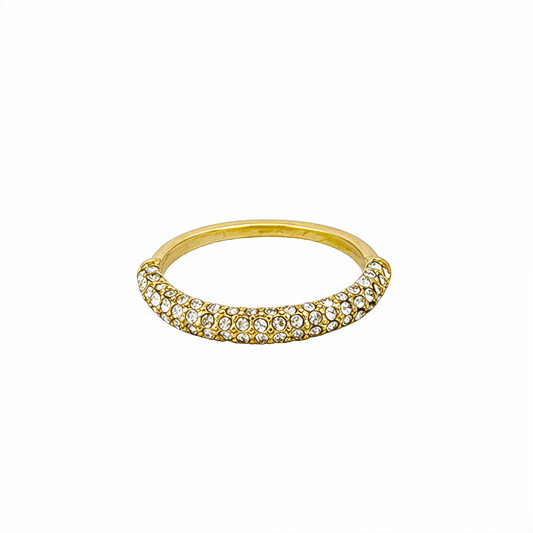 Gold pavé crystal ring on a white display stand — MXW Jewellery product photo.