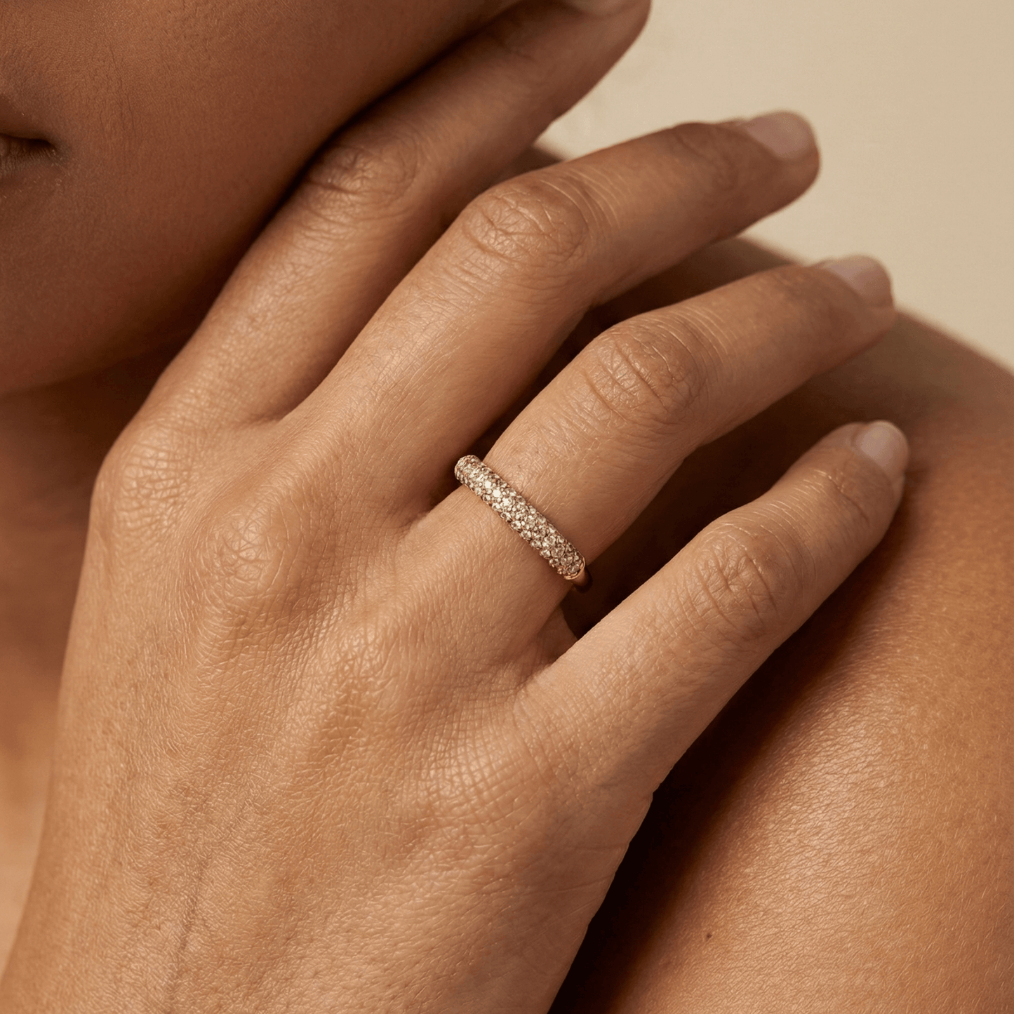 Gold pavé crystal ring on a white display stand — MXW Jewellery product photo.