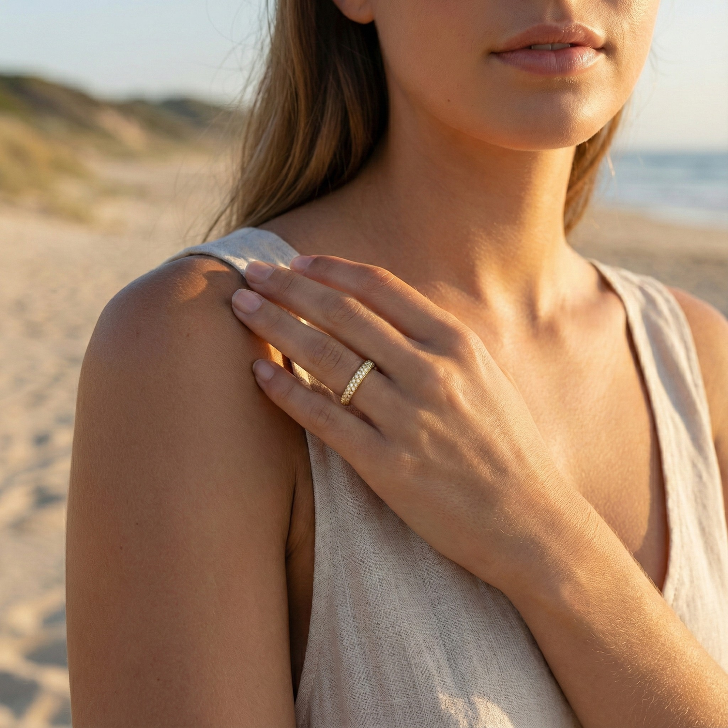 Gold pavé crystal ring on a white display stand — MXW Jewellery product photo.