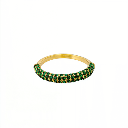 Gold pavé ring with emerald-green crystals in a curved arc design.