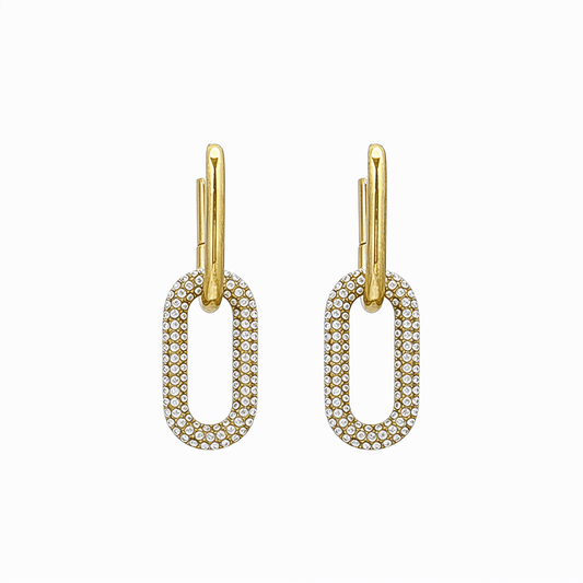 Gold pavé link drop earrings with an elongated sparkling charm hanging from a smooth gold huggie.