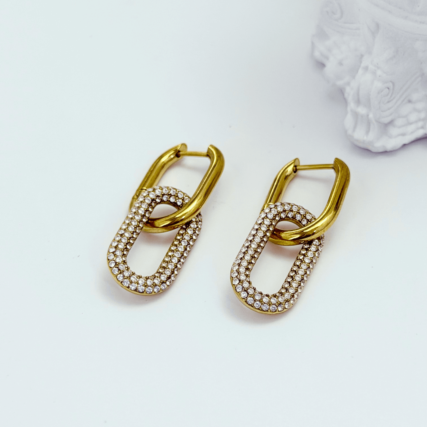 Gold pavé link drop earrings with an elongated sparkling charm hanging from a smooth gold huggie.