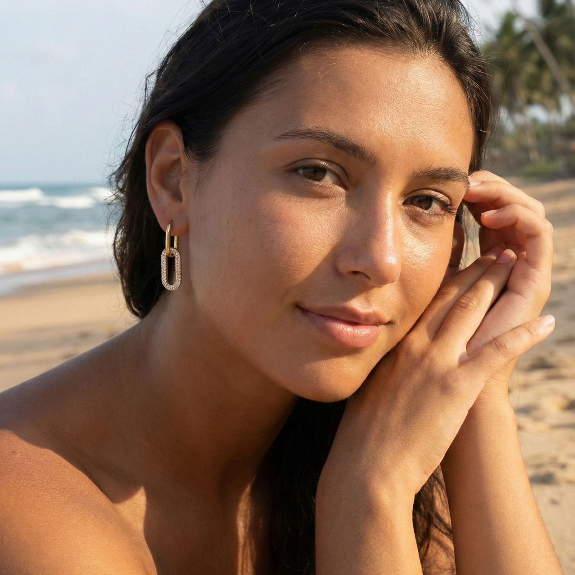 Gold pavé link drop earrings with an elongated sparkling charm hanging from a smooth gold huggie.