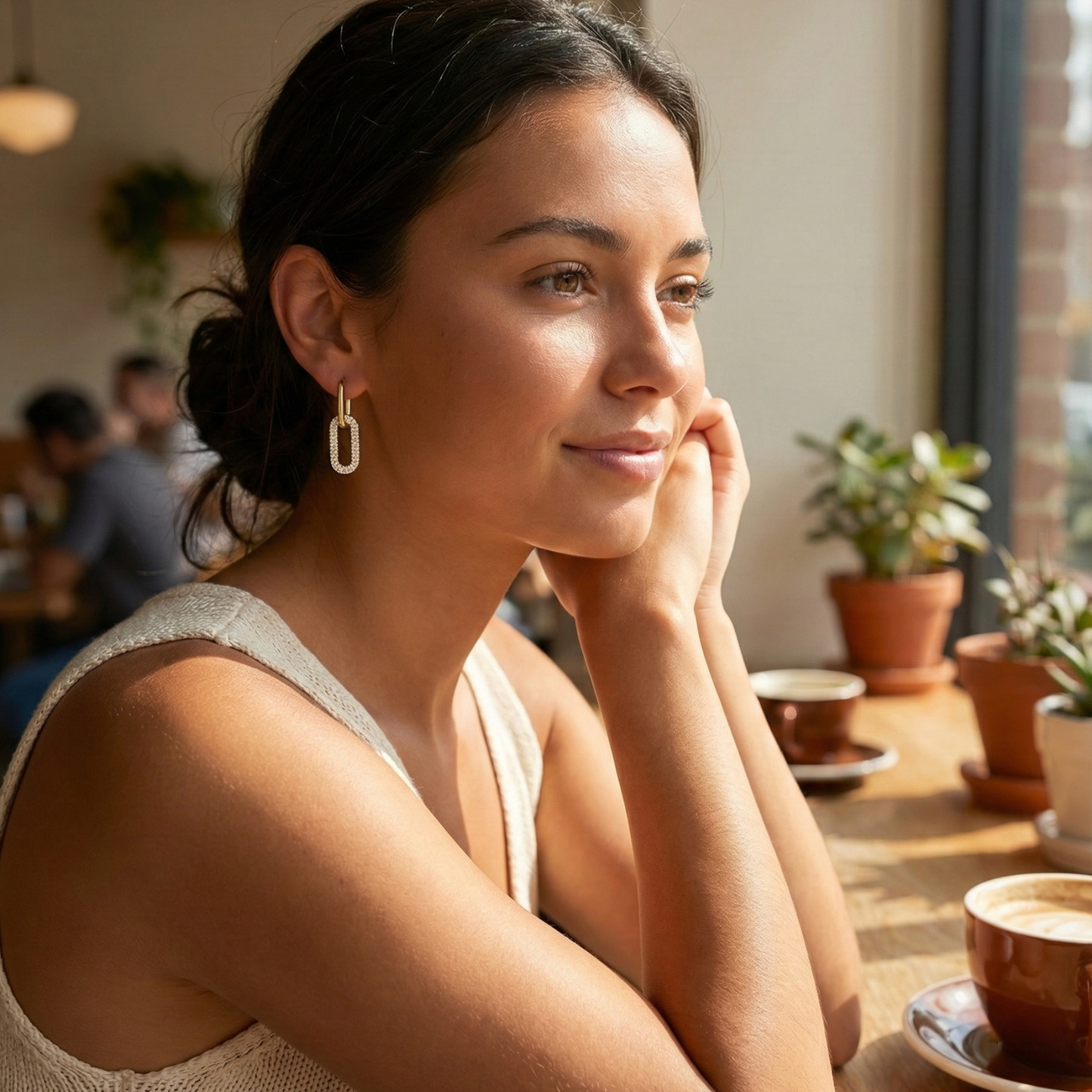 Gold pavé link drop earrings with an elongated sparkling charm hanging from a smooth gold huggie.