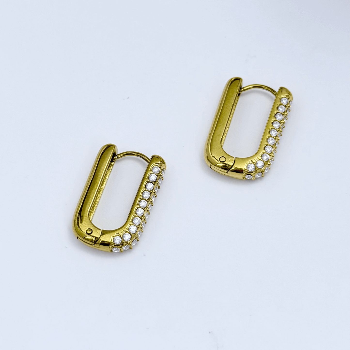 Pavé rectangular gold huggie earrings with modern geometric shape.