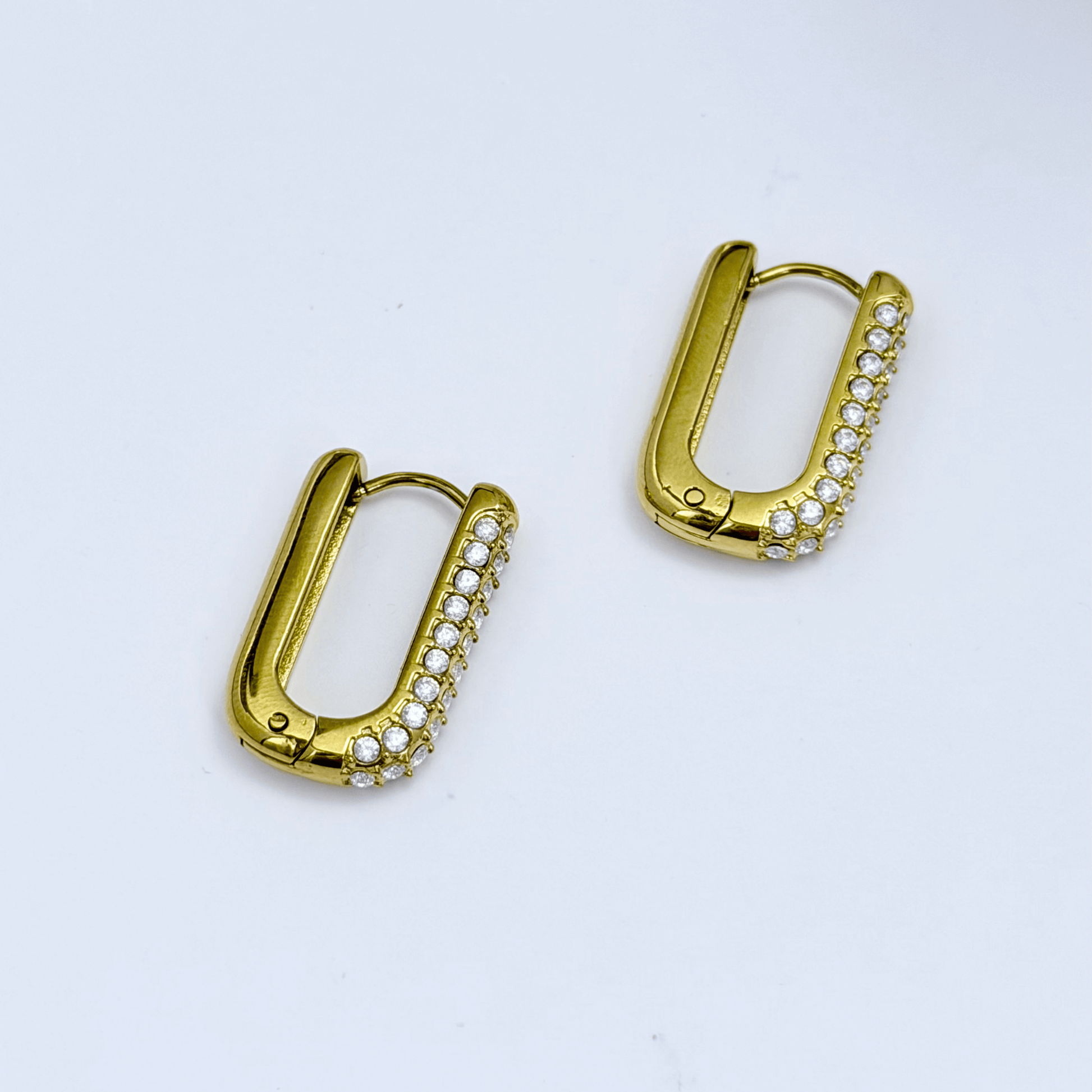 Pavé rectangular gold huggie earrings with modern geometric shape.