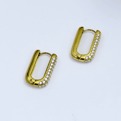 Pavé rectangular gold huggie earrings with modern geometric shape.