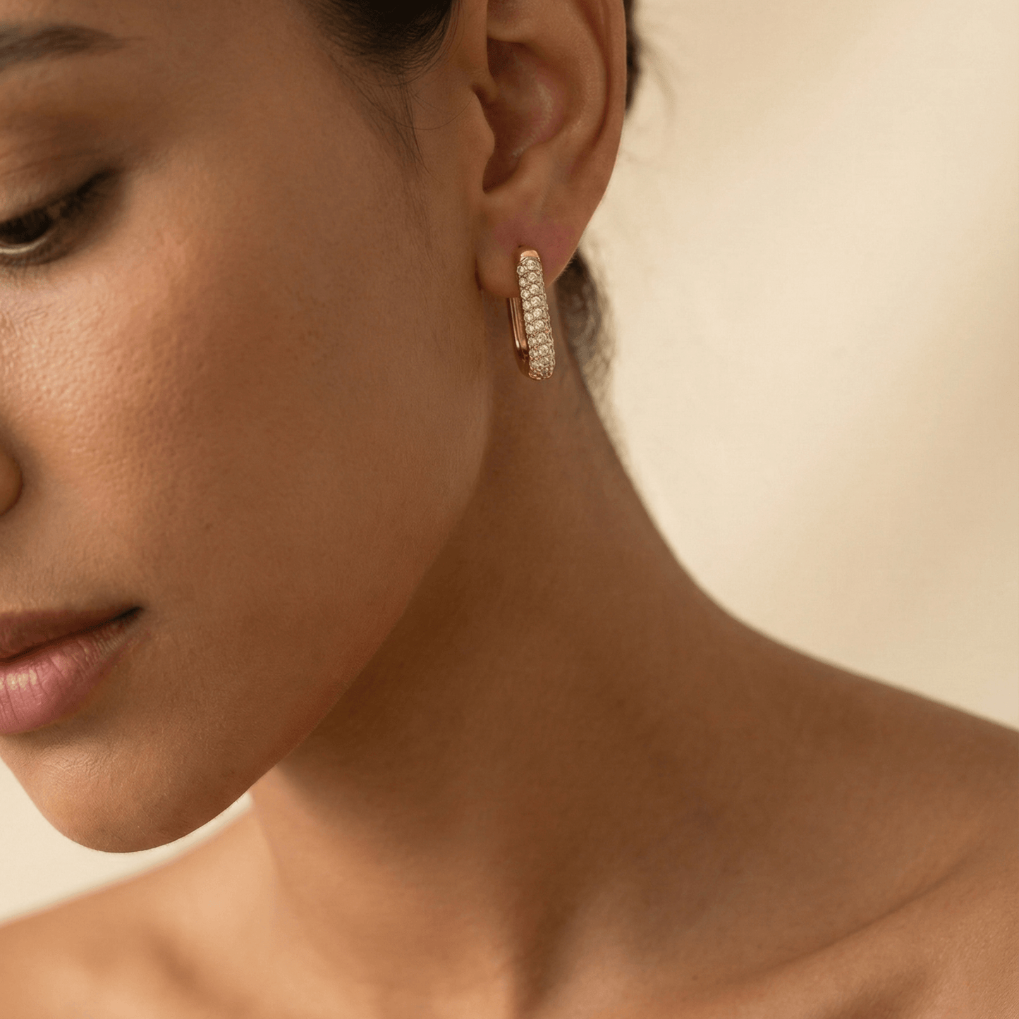 Pavé rectangular gold huggie earrings with modern geometric shape.