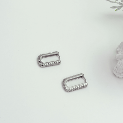 Pavé rectangular silver huggie earrings with crystal detailing.