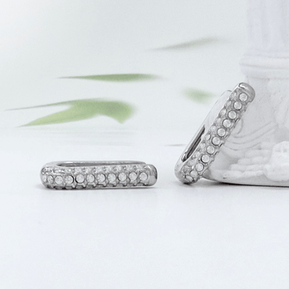 Pavé rectangular silver huggie earrings with crystal detailing.