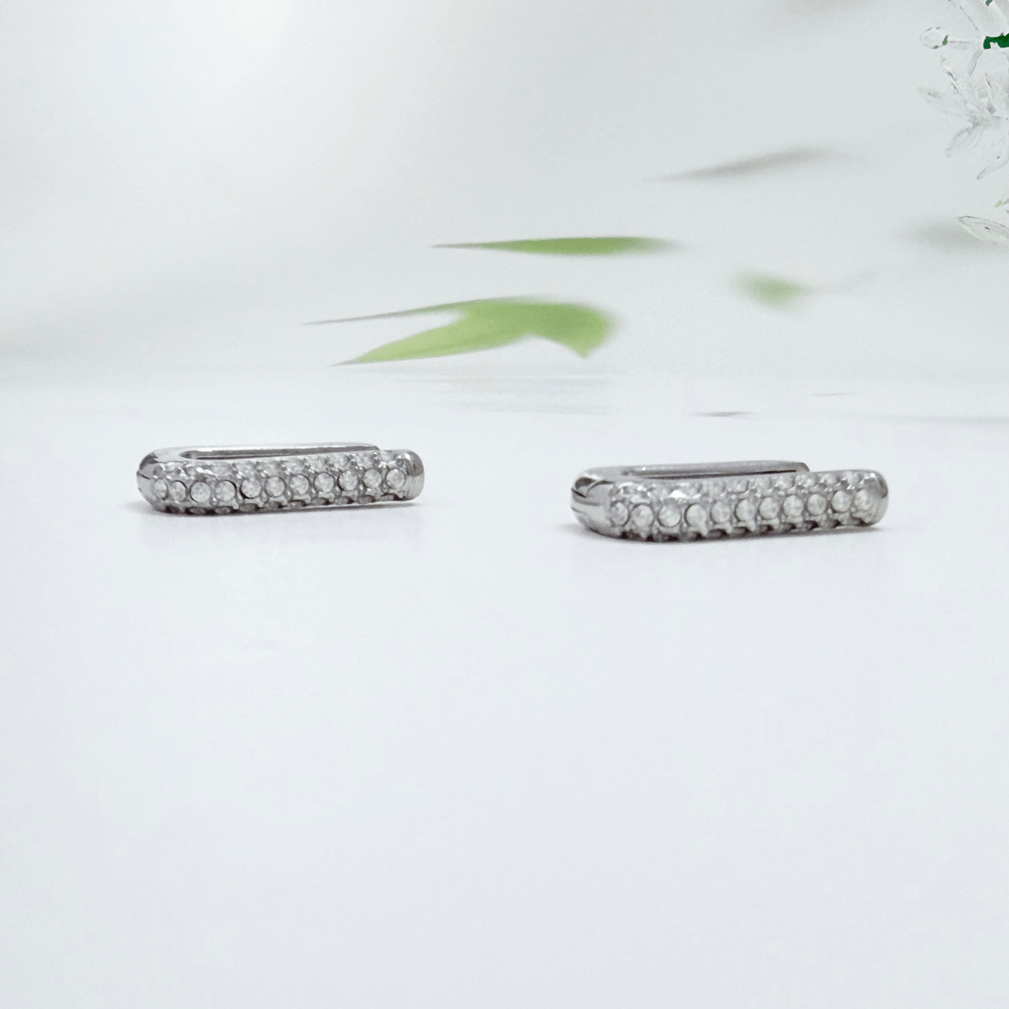 Pavé rectangular silver huggie earrings with crystal detailing.