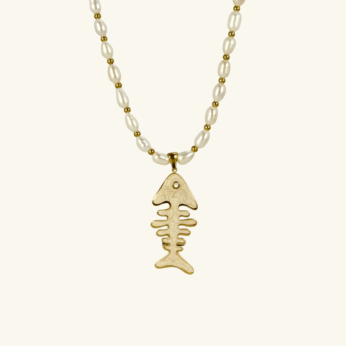 Pearl and gold fishbone necklace symbolizing resilience and good fortune