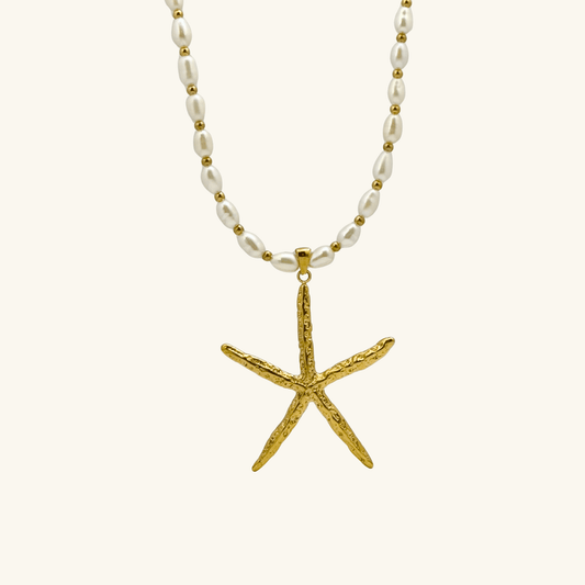 Bold gold starfish pendant on freshwater pearl necklace