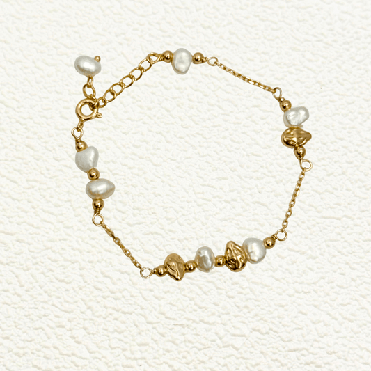 bracelet featuring petite freshwater pearls and molten gold beads on a fine gold chain with adjustable extender