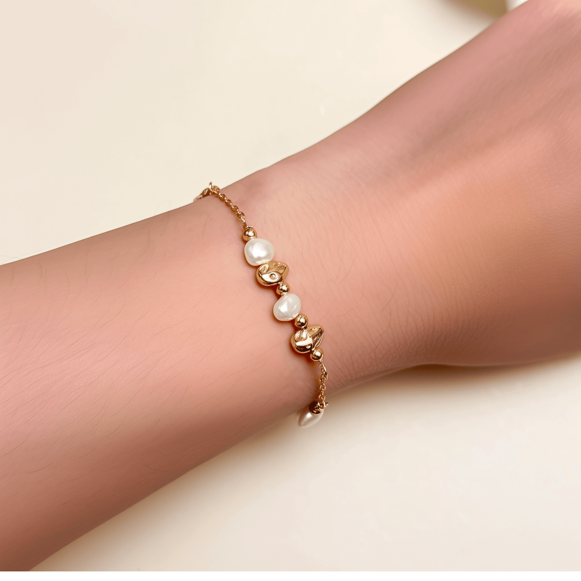 bracelet featuring petite freshwater pearls and molten gold beads on a fine gold chain with adjustable extender