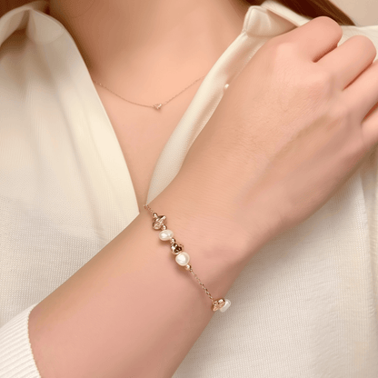 bracelet featuring petite freshwater pearls and molten gold beads on a fine gold chain with adjustable extender