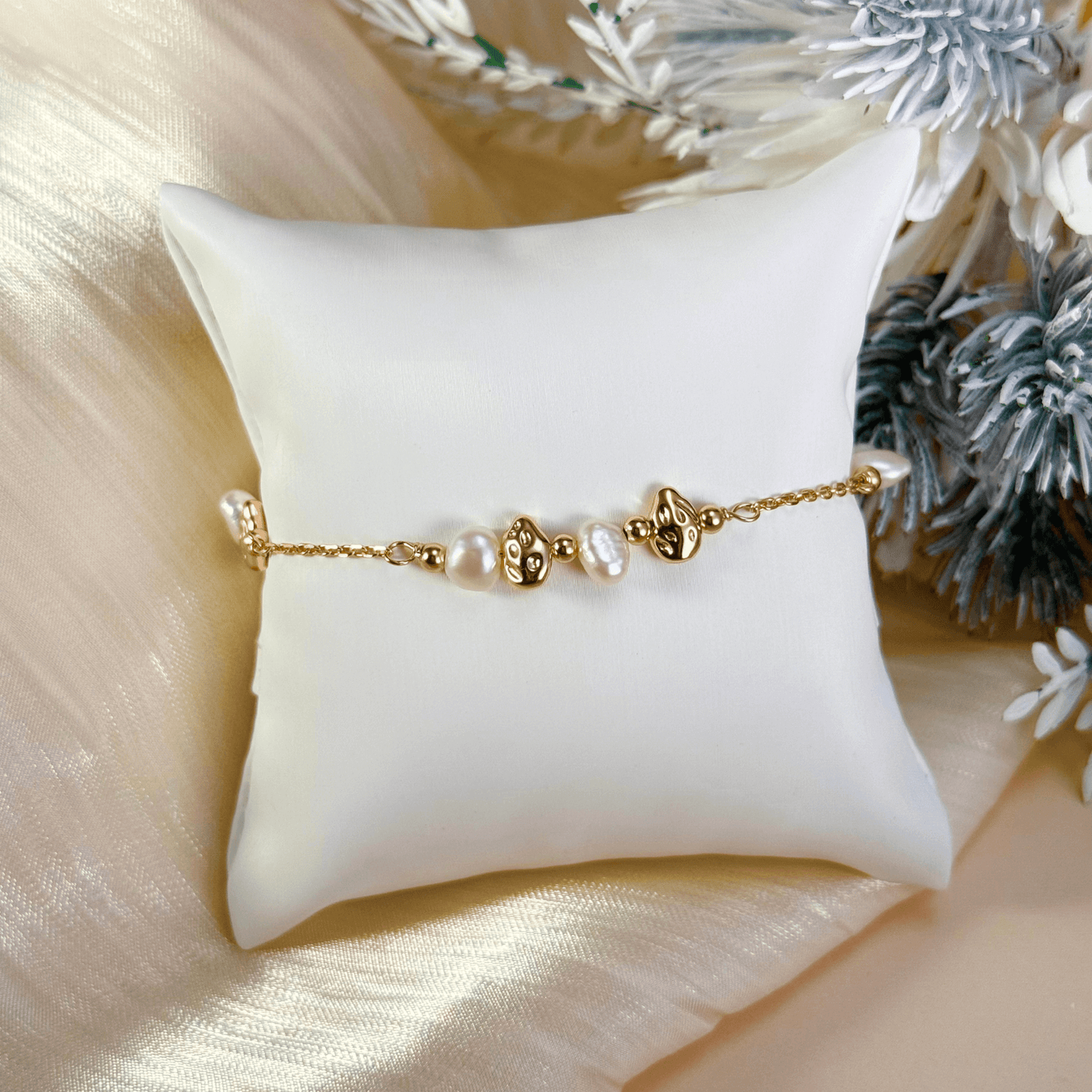bracelet featuring petite freshwater pearls and molten gold beads on a fine gold chain with adjustable extender