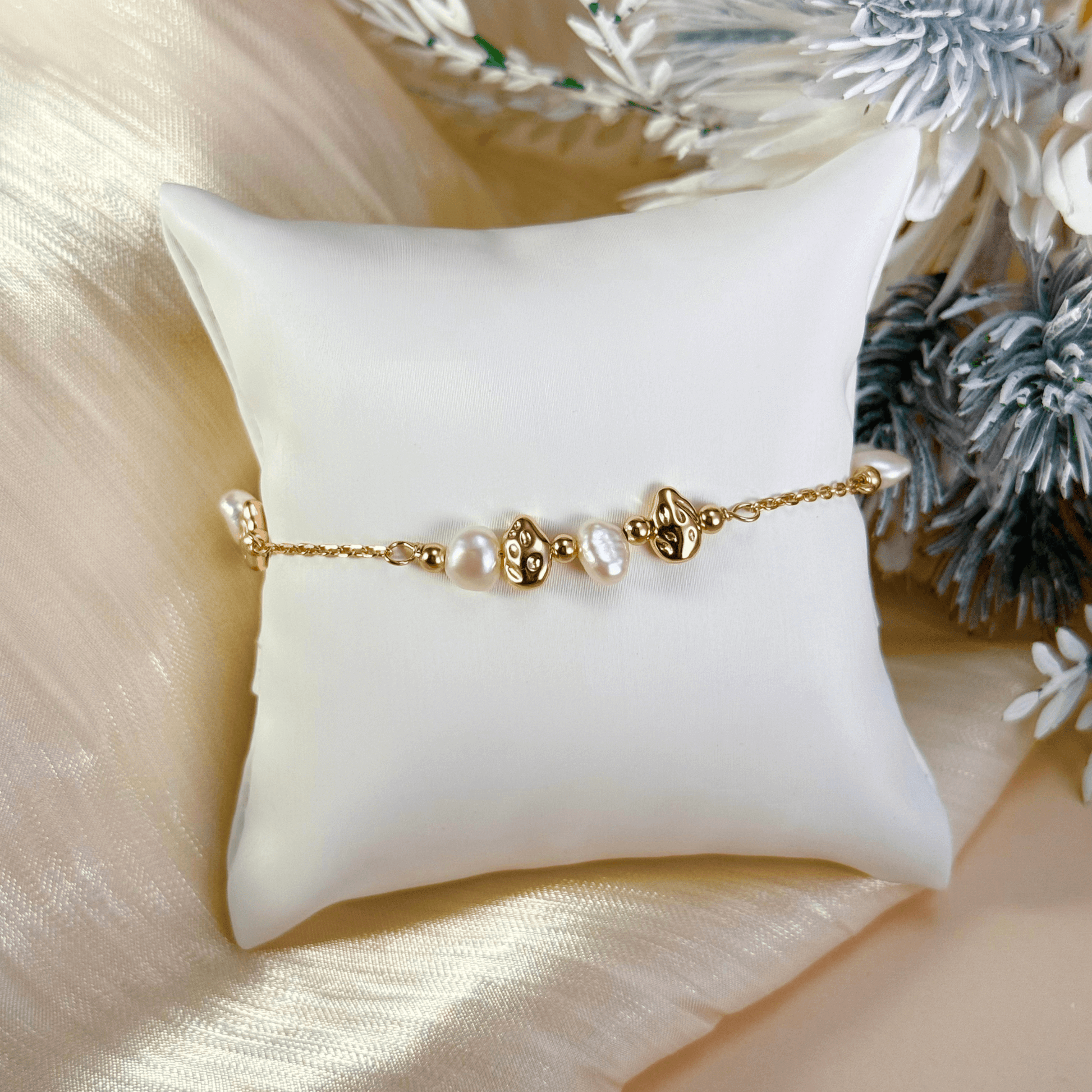 bracelet featuring petite freshwater pearls and molten gold beads on a fine gold chain with adjustable extender