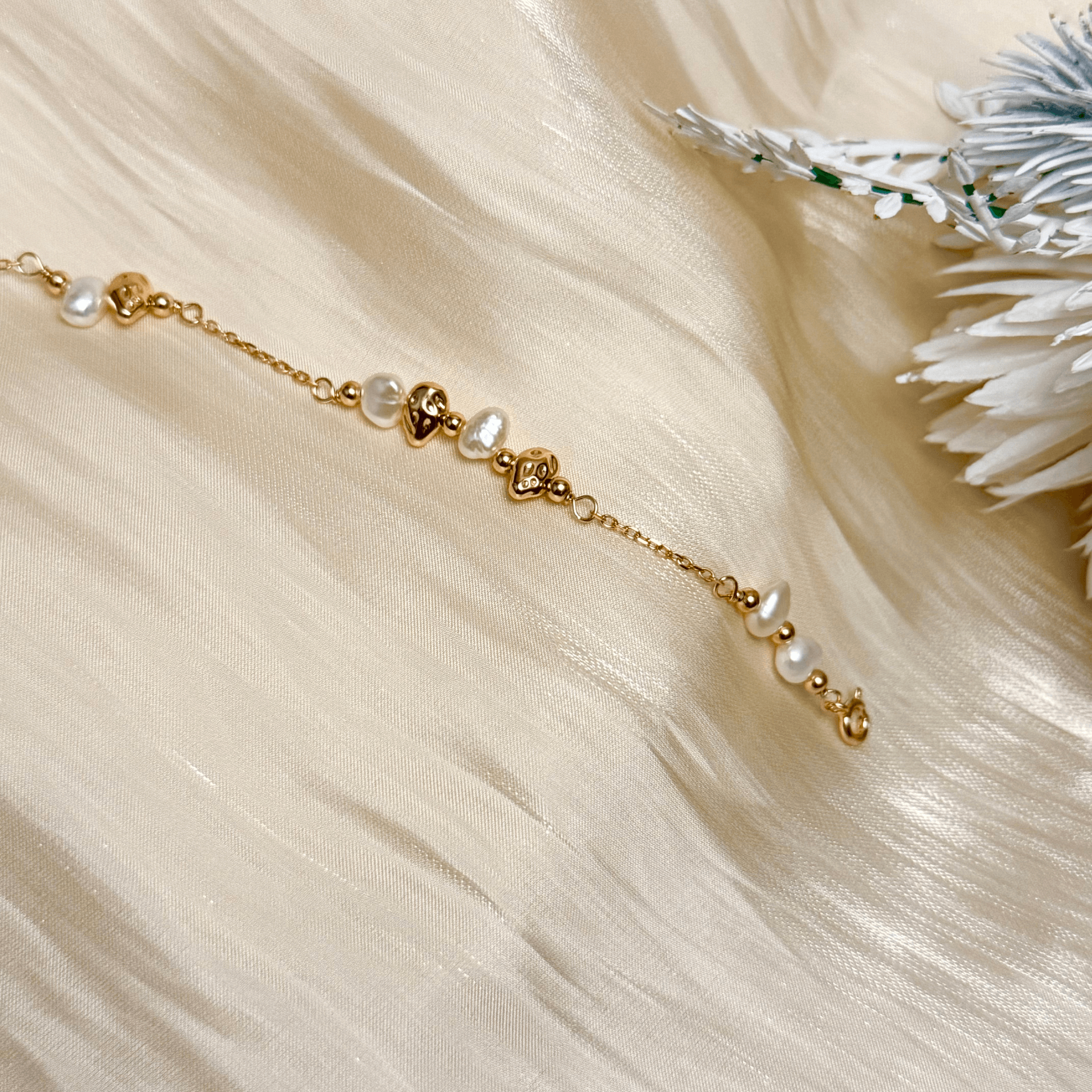 bracelet featuring petite freshwater pearls and molten gold beads on a fine gold chain with adjustable extender