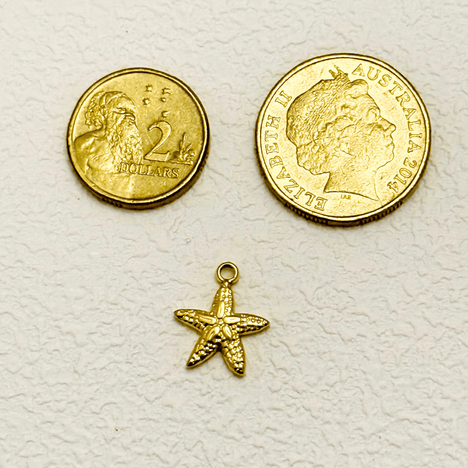 Small textured starfish charm in PVD gold plating, perfect for ocean-themed jewellery