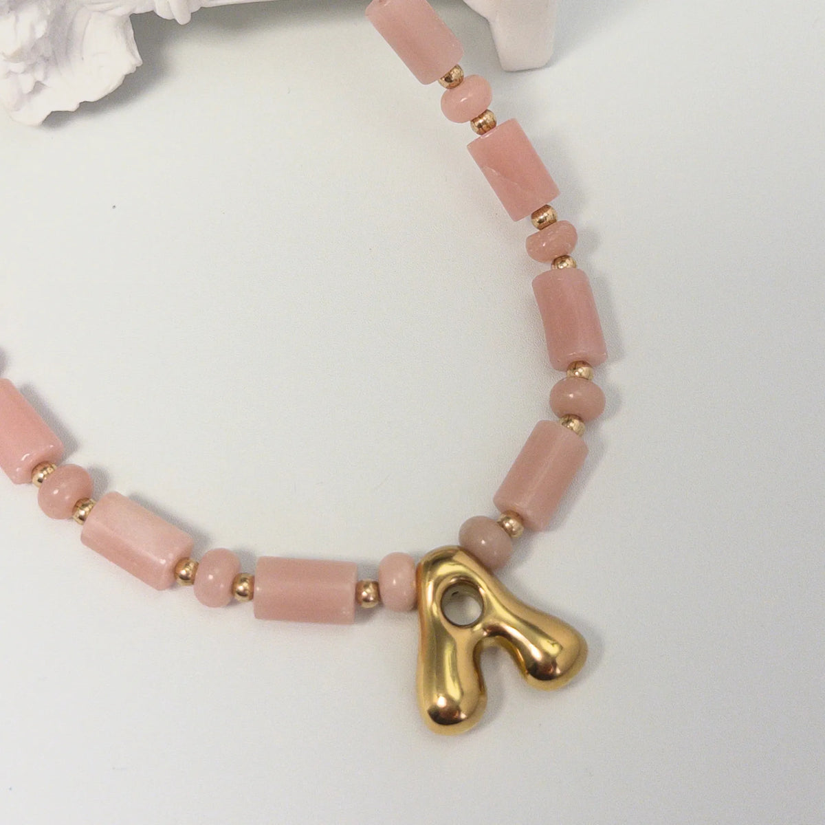 Pink opal initial necklace with barrel and rondelle beads, 14K gold filled spacers and a bubble letter pendant