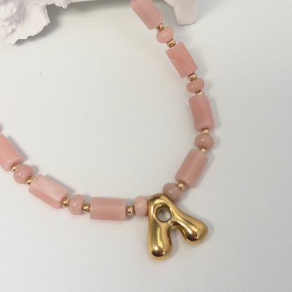 Pink opal initial necklace with barrel and rondelle beads, 14K gold filled spacers and a bubble letter pendant