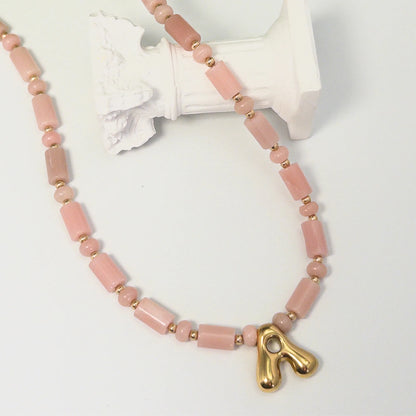 Pink opal initial necklace with barrel and rondelle beads, 14K gold filled spacers and a bubble letter pendant