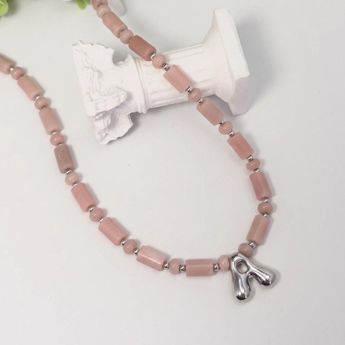 Pink opal initial necklace with barrel and rondelle beads, sterling silver spacers and a bubble letter pendant