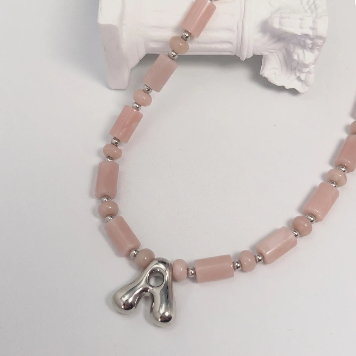 Pink opal initial necklace with barrel and rondelle beads, sterling silver spacers and a bubble letter pendant