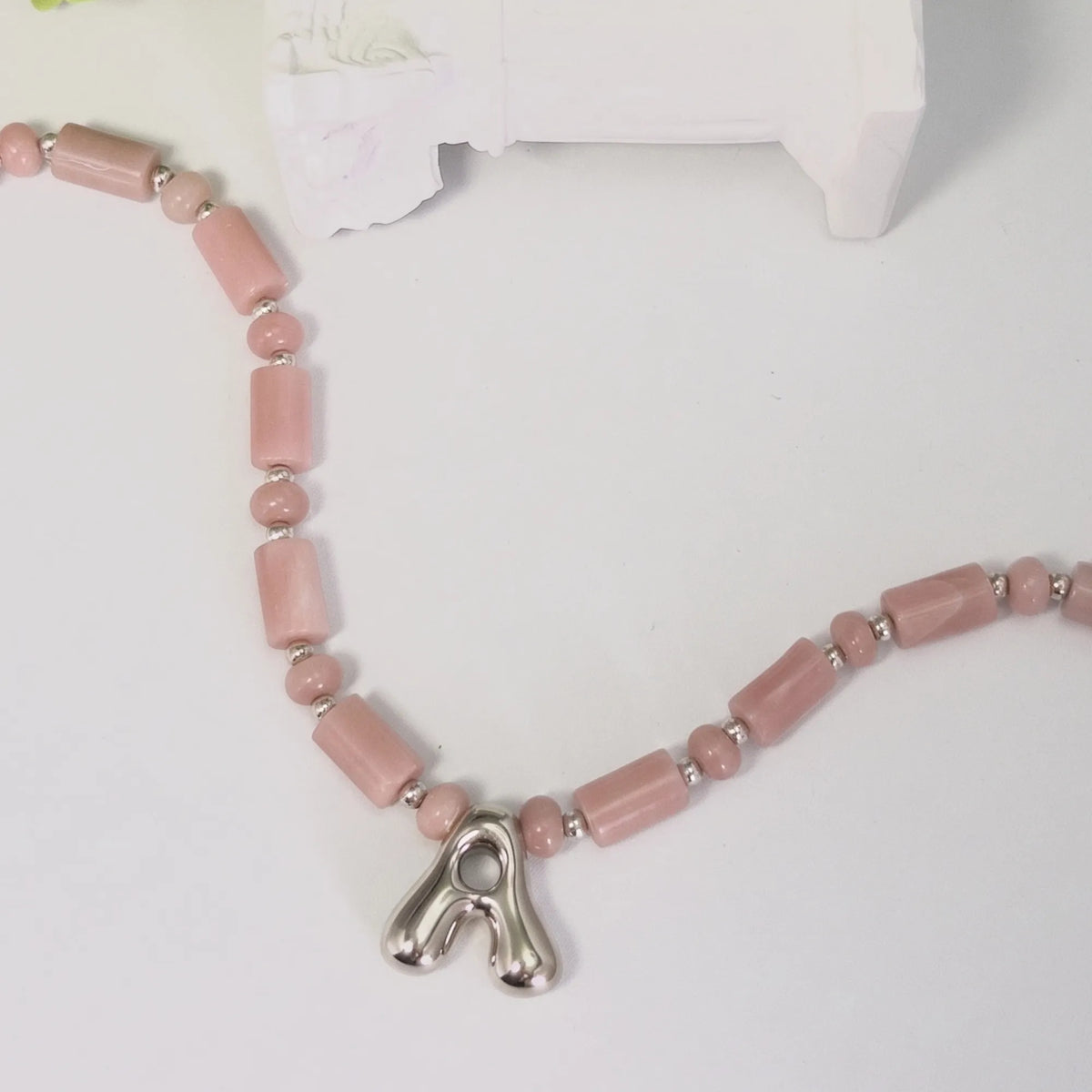 Pink opal initial necklace with barrel and rondelle beads, sterling silver spacers and a bubble letter pendant