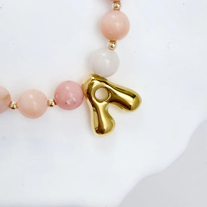 Pink opal beaded necklace with gold filled spacer beads and gold initial pendant MXW Jewellery