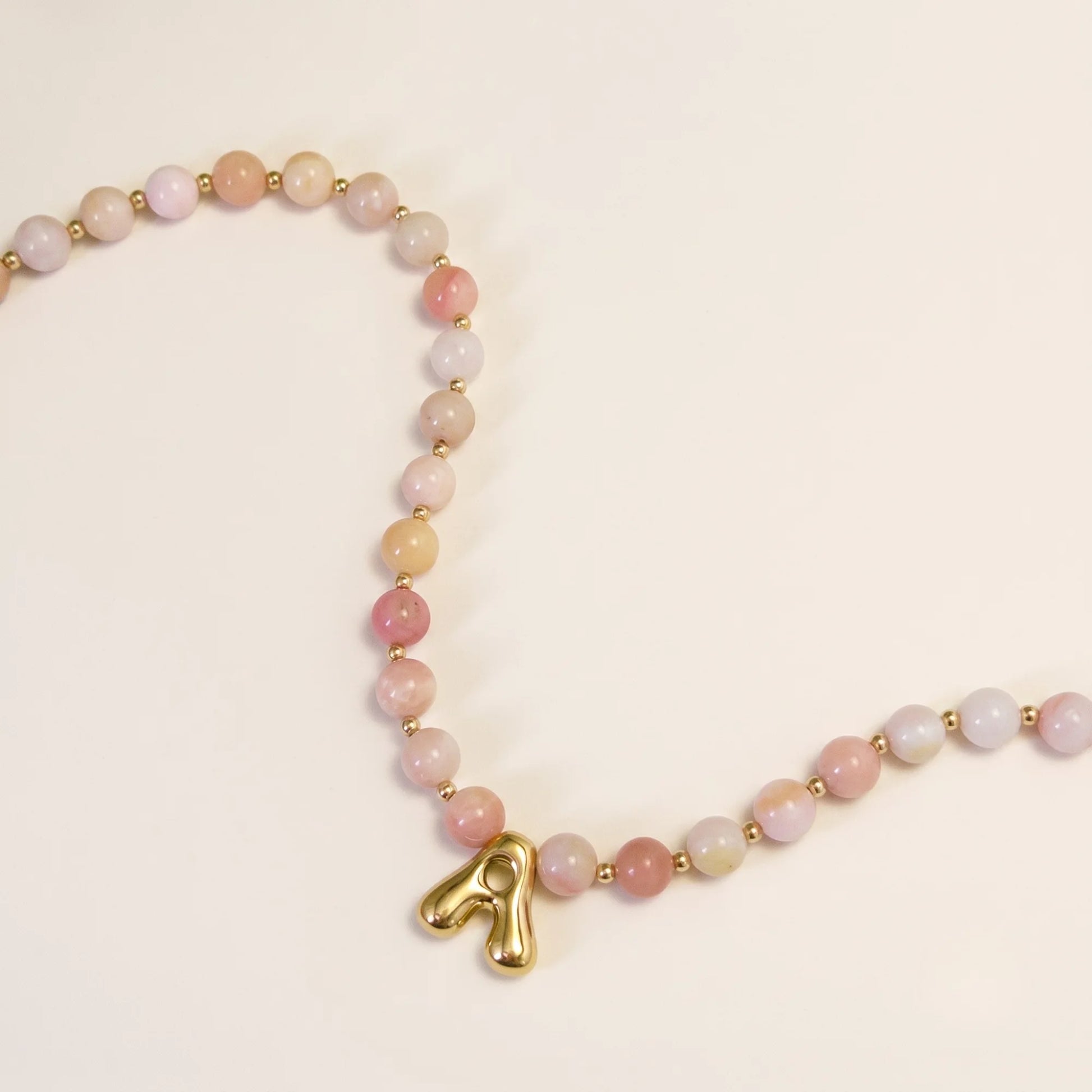 Pink opal beaded necklace with gold filled spacer beads and gold initial pendant MXW Jewellery