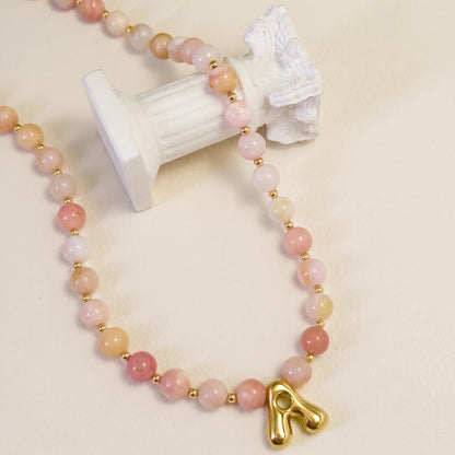 Pink opal beaded necklace with gold filled spacer beads and gold initial pendant MXW Jewellery