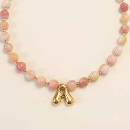 Pink opal beaded necklace with gold filled spacer beads and gold initial pendant MXW Jewellery