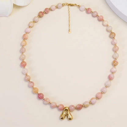 Pink opal beaded necklace with gold filled spacer beads and gold initial pendant MXW Jewellery