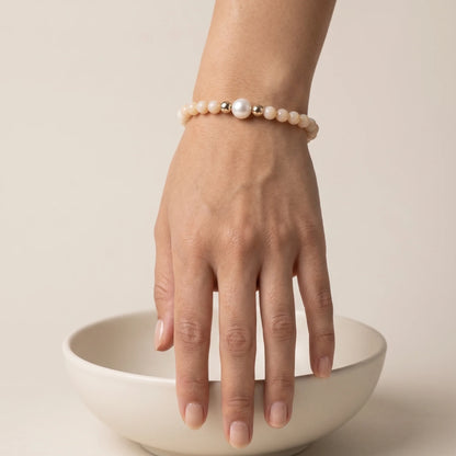 Pink opal, pearl and initial gold bracelet featuring soft pink gemstone beads, lustrous freshwater pearls and a personalised gold-filled stamped initial disc.