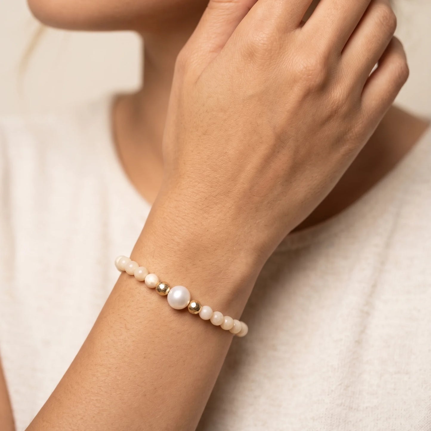 Pink opal, pearl and initial gold bracelet featuring soft pink gemstone beads, lustrous freshwater pearls and a personalised gold-filled stamped initial disc.