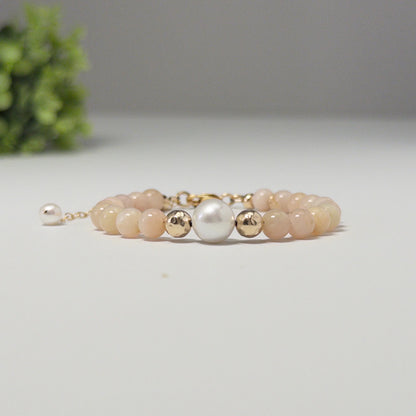 Pink opal, pearl and initial gold bracelet featuring soft pink gemstone beads, lustrous freshwater pearls and a personalised gold-filled stamped initial disc.
