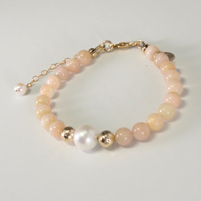 Pink opal, pearl and initial gold bracelet featuring soft pink gemstone beads, lustrous freshwater pearls and a personalised gold-filled stamped initial disc.