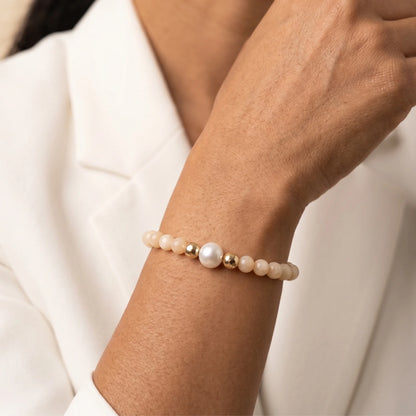 Pink opal, pearl and initial gold bracelet featuring soft pink gemstone beads, lustrous freshwater pearls and a personalised gold-filled stamped initial disc.