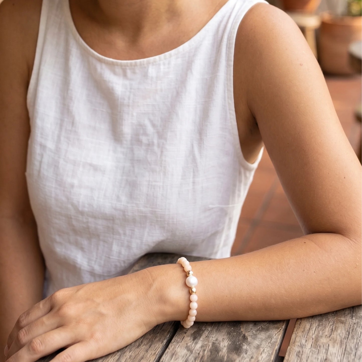 Pink opal, pearl and initial gold bracelet featuring soft pink gemstone beads, lustrous freshwater pearls and a personalised gold-filled stamped initial disc.
