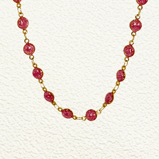 Gold PVD stainless steel chain with glossy pink glaze drip beads evenly spaced, designed for customisable wear as necklace, anklet, or bracelet.
